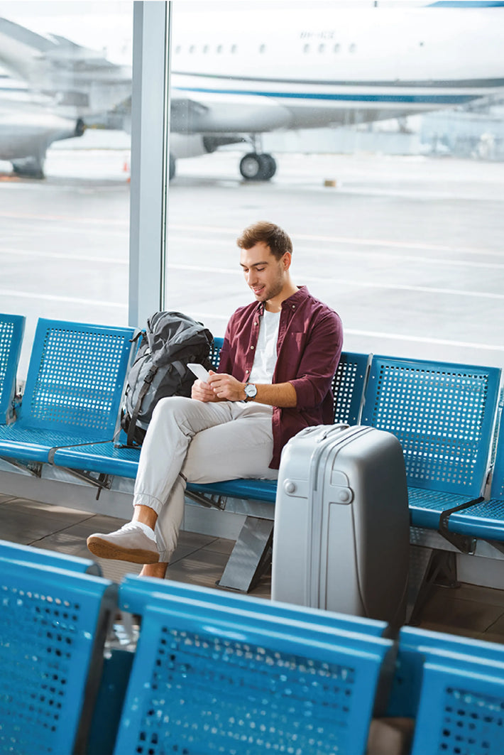 Traveler using ONE Pocket WiFi for stable internet connection on the go.